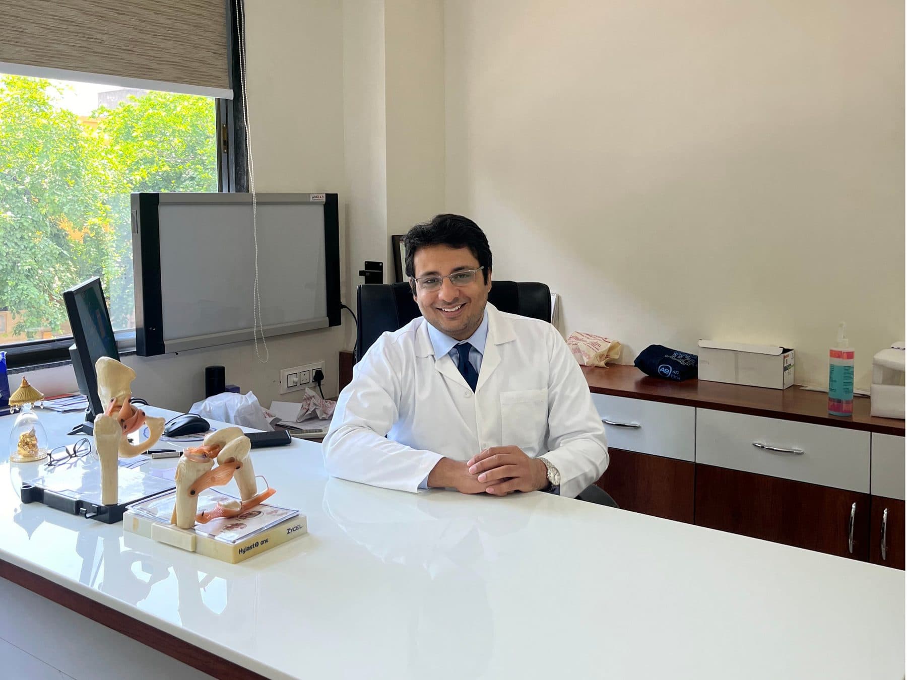 Dr. Yash Shah in his consultation room at Bodyline Hospital, Paldi